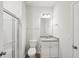 This bathroom features a glass shower, toilet, vanity, and bright lighting at 11854 Rizvan Pl, Covington, GA 30014