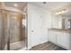 Bright bathroom with a glass shower, double vanity, and granite countertops at 11854 Rizvan Pl, Covington, GA 30014