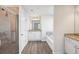 Bright bathroom featuring a glass shower, double vanity, and a soaking tub at 11854 Rizvan Pl, Covington, GA 30014