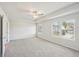 Spacious bedroom featuring a ceiling fan, and windows at 11854 Rizvan Pl, Covington, GA 30014