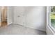 Bright bedroom featuring neutral carpeting, a closet, and a window letting in natural light at 11854 Rizvan Pl, Covington, GA 30014