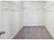 Spacious walk-in closet with wire shelving and carpeted floor at 11854 Rizvan Pl, Covington, GA 30014