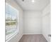 Well-lit walk-in closet with shelving, carpet, and a window at 11854 Rizvan Pl, Covington, GA 30014