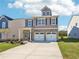 Attractive two-story home with a brick front, double garage, and a neatly landscaped lawn at 11854 Rizvan Pl, Covington, GA 30014