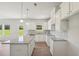 An open kitchen featuring white cabinets, granite countertops and stainless steel appliances at 11854 Rizvan Pl, Covington, GA 30014