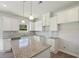 Open kitchen with white cabinets, granite countertops and a spacious island at 11854 Rizvan Pl, Covington, GA 30014