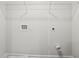 A basic laundry room with hookups and a wire shelf at 11854 Rizvan Pl, Covington, GA 30014