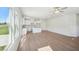 Bright living space featuring large windows, a modern kitchen with an island, and sleek floors at 11854 Rizvan Pl, Covington, GA 30014