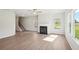 Cozy living area with fireplace, lots of windows, and sleek flooring at 11854 Rizvan Pl, Covington, GA 30014