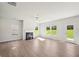 Spacious living room with fireplace, ceiling fan and large windows bringing in natural light at 11854 Rizvan Pl, Covington, GA 30014
