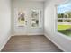 Sun-drenched sunroom offering abundant natural light through large windows and access to the backyard at 11854 Rizvan Pl, Covington, GA 30014