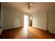 Cozy bedroom features hardwood floors, light walls, ceiling fan and closet space at 1398 Christmas Ne Ln, Atlanta, GA 30329