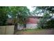 Rear exterior view of a brick house with a small deck and a stone foundation at 1398 Christmas Ne Ln, Atlanta, GA 30329
