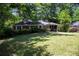 Charming brick home featuring a well-manicured front yard with mature trees at 1398 Christmas Ne Ln, Atlanta, GA 30329