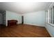Living room with hardwood floors, light blue walls, and a vintage piano at 1398 Christmas Ne Ln, Atlanta, GA 30329