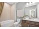 Well-lit bathroom featuring a combined tub and shower with modern vanity and neutral color palette at 244 Nesta Grove, Locust Grove, GA 30248