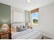 Charming bedroom with large window, complemented by neutral decor and comfortable furnishings at 244 Nesta Grove, Locust Grove, GA 30248
