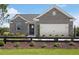 Charming single-Gathering home with gray brick, black fence, and manicured landscaping at 244 Nesta Grove, Locust Grove, GA 30248