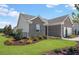 Beautiful gray brick home exterior showcasing manicured lawn and complementing neutral trim at 244 Nesta Grove, Locust Grove, GA 30248