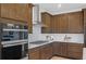 Elegant kitchen with stainless steel appliances, quartz countertops, and modern cabinetry at 244 Nesta Grove, Locust Grove, GA 30248