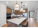 Stylish kitchen with stainless steel appliances, quartz countertops, and center island with bar stool seating at 244 Nesta Grove, Locust Grove, GA 30248
