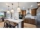 Modern kitchen featuring stainless steel appliances, a large island, and pendant lighting at 244 Nesta Grove, Locust Grove, GA 30248