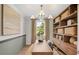 Home office area with built-in shelves, natural light, and a sleek desk at 244 Nesta Grove, Locust Grove, GA 30248