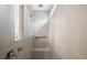 Walk-in shower with gray tiling, a built-in shelf, and modern shower head at 244 Nesta Grove, Locust Grove, GA 30248