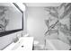 Bathroom featuring a sink vanity and a toilet against a grey and white marble wall at 3355 Wesley Chapel Rd, Decatur, GA 30034