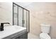 Modern bathroom featuring a glass shower, toilet, and dark vanity at 3355 Wesley Chapel Rd, Decatur, GA 30034