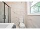 Modern bathroom featuring sleek, white tile, and a glass enclosed shower at 3355 Wesley Chapel Rd, Decatur, GA 30034