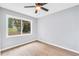 Empty bedroom with vinyl flooring, a ceiling fan, and a window at 3355 Wesley Chapel Rd, Decatur, GA 30034