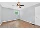 Bright bedroom with sleek hardwood flooring, a window, and a ceiling fan at 3355 Wesley Chapel Rd, Decatur, GA 30034