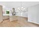 Open concept kitchen and dining area featuring deck access, a modern light fixture and light-colored walls at 3355 Wesley Chapel Rd, Decatur, GA 30034