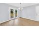Dining room with new wood flooring and deck access through double doors at 3355 Wesley Chapel Rd, Decatur, GA 30034