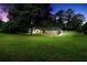 Exterior shot of the home with a large lawn and mature trees at 3355 Wesley Chapel Rd, Decatur, GA 30034