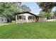 The home has a charming exterior with a well-manicured lawn and mature trees at 3355 Wesley Chapel Rd, Decatur, GA 30034