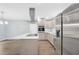 Modern kitchen with stainless steel appliances, a kitchen island with white marble countertop and stainless steel exhaust hood at 3355 Wesley Chapel Rd, Decatur, GA 30034