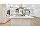 Modern kitchen with stainless steel appliances, island cooktop, stainless steel exhaust hood, and marble countertops at 3355 Wesley Chapel Rd, Decatur, GA 30034