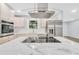 Modern kitchen featuring stainless steel appliances, white marble countertops, and a cooktop on the kitchen island at 3355 Wesley Chapel Rd, Decatur, GA 30034