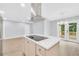 Modern kitchen with stainless steel appliances, island cooktop, stainless steel exhaust hood, and backyard deck access at 3355 Wesley Chapel Rd, Decatur, GA 30034