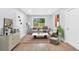 Bright living room featuring a large window, neutral decor, and wood floors at 3355 Wesley Chapel Rd, Decatur, GA 30034