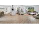 Open-concept living space with a modern kitchen and a cozy living area with natural light at 3355 Wesley Chapel Rd, Decatur, GA 30034