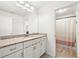 Well-lit bathroom featuring vanity with granite counters, white cabinetry, and a shower-tub combo at 4044 Andover Cir, Mcdonough, GA 30252