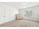 Minimalist bedroom with a dresser, neutral carpet, and a window bringing in plenty of natural light at 4044 Andover Cir, Mcdonough, GA 30252