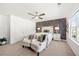 Bright bedroom featuring decorative wallpaper, white furnishings, and a large window showcasing the neighborhood at 4044 Andover Cir, Mcdonough, GA 30252