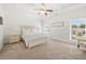 Primary bedroom with neutral colors, tray ceiling, ceiling fan and carpet at 4044 Andover Cir, Mcdonough, GA 30252