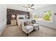 Well-lit bedroom with decorative wallpaper, stylish furnishings, and a large window showcasing the neighborhood at 4044 Andover Cir, Mcdonough, GA 30252