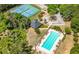 Aerial view showcasing the community's swimming pool and tennis courts with landscaping and trees at 4044 Andover Cir, Mcdonough, GA 30252