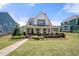 Charming two-story home with a welcoming front porch and beautifully landscaped front yard at 4044 Andover Cir, Mcdonough, GA 30252